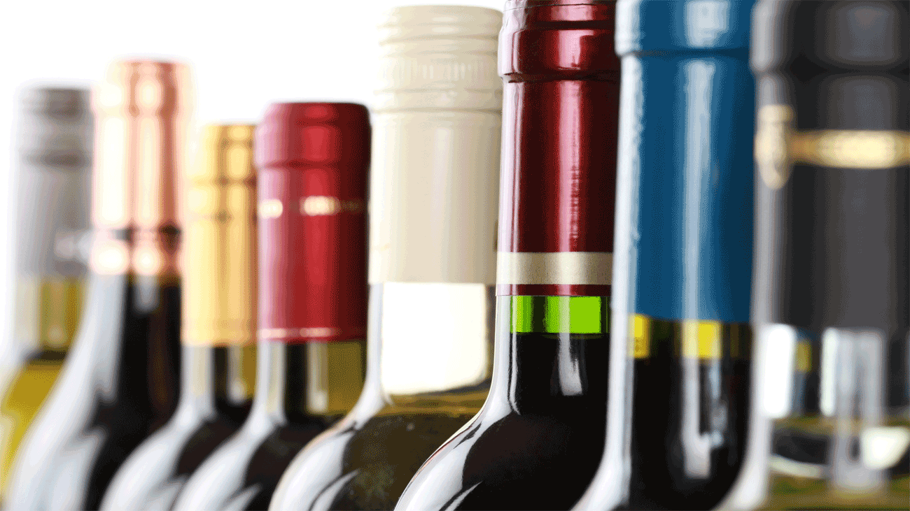 Wine club membership cost comparison with bottles and pricing on a table